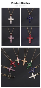 Macro detail of copper cross necklaces with colorful cubic zirconia on gold chains