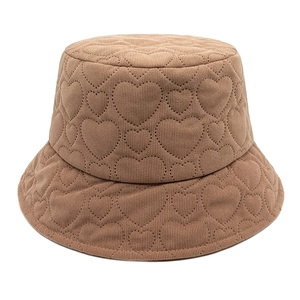 Detailed view of heart-shaped quilted stitching on winter corduroy bucket hat fabric