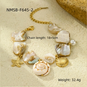 Detail of beach bracelet with starfish, seashells, and pearl charms on golden chain