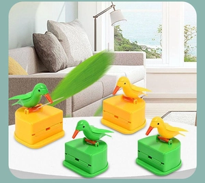 Close-up of bird-shaped toothpick dispensers in yellow and green showing functional beak