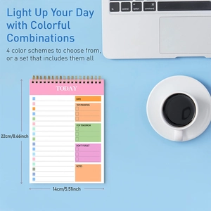 Flat lay of daily planner notepad with time management sections on a blue workspace