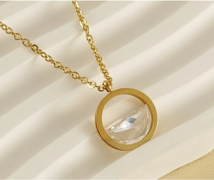 Macro shot of 18K gold plated stainless steel necklace with round crystal pendant detail
