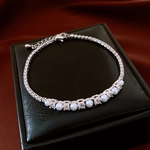 Close-up of zircon pearl chain bracelet on a premium black leather jewelry gift box