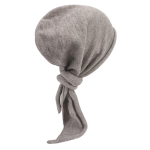 Detailed close-up of the grey knit fabric texture and knot design on the turban hat