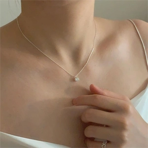 Elegant 925 sterling silver necklace with round zircon pendant on a model