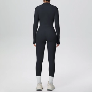 Close-up of black yoga set featuring thumbhole cuffs and high-waist body-shaping leggings