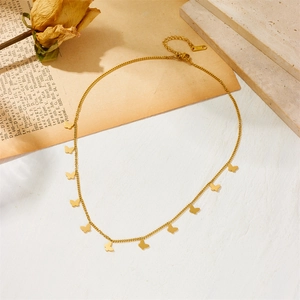 Minimalist gold necklace with multiple butterfly pendants on a vintage background
