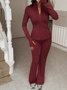 Close-up of burgundy Y2K sports set with zipper top and flared yoga pants