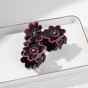 Elegant flower petal hair claw clip in black and rose red with sparkling rhinestones