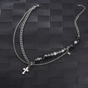 Double-layered silver necklace with cross pendant, Cuban chain, and black-white beads