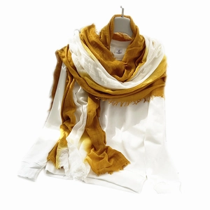 Japanese style yellow and white gradient linen scarf with raw edges on a white hanger