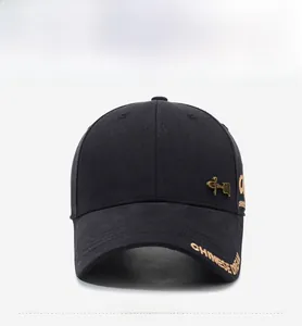 Macro detail of Chinese Dream gold embroidery on a black cotton baseball cap