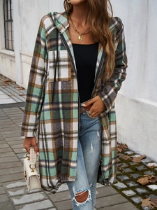 Detail of green and brown plaid hooded jacket with black zipper and chest pockets