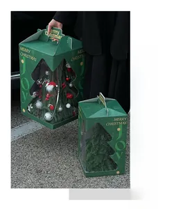 Detail of Christmas tree gift boxes with festive gold lettering and clear window design
