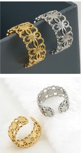 Close-up of hollow floral pattern adjustable rings in gold and silver finishes