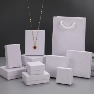 Collection of white lychee textured jewelry boxes and matching paper gift bag