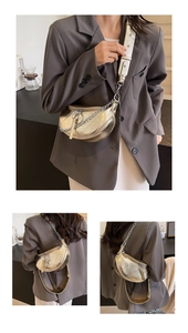 Detail view of a gold crescent bag with metallic texture and versatile shoulder straps