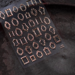 3D embossed vintage bronze frame nail art stickers with metallic texture on dark background