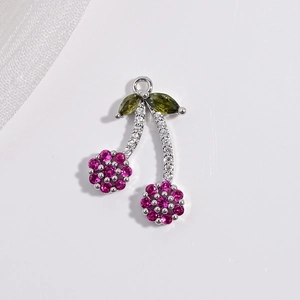 Detail of copper cherry pendant with pink and green sparkling cubic zirconia crystals