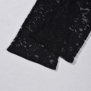 Macro shot of delicate black lace fabric with intricate floral cutout patterns