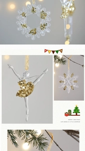 Detailed view of clear acrylic snowflake and ballerina ornaments with gold glitter accents