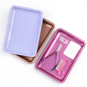 Detailed set of three colorful metal trays with essential manicure tools on white background
