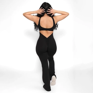 Rear view of black backless jumpsuit featuring ruched bum lifting and flared leg design