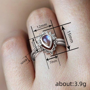 Water drop moonstone ring with zircon halo and double silver band on hand