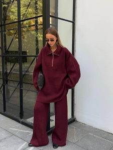 Two-piece ribbed knit tracksuit featuring a half-zip sweater and wide-leg trousers in burgundy