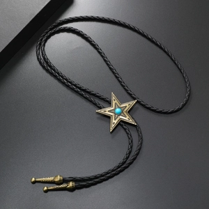 Detail of vintage bolo tie with bronze star pendant and turquoise stone on black braided cord