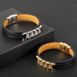 Men's leather strap bracelet with stainless steel accents and diamonds on a gift box