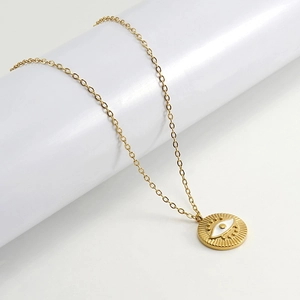 18K gold plated stainless steel necklace with evil eye pendant on a white pedestal