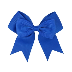 Detailed close-up of a royal blue grosgrain ribbon hair bow with premium textured finish