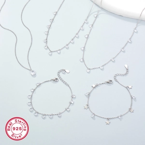 Macro shot of S925 sterling silver jewelry set featuring teardrop zircons and stars