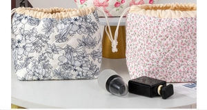 Detail of quilted cotton drawstring makeup bags featuring floral and bow patterns