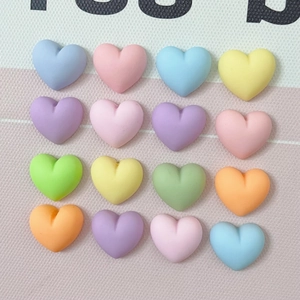 Macro view of 16 macaron-colored resin hearts in a 4x4 grid for DIY crafts
