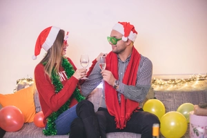 Close-up of festive LED party glasses and Christmas accessories in a cozy party setting