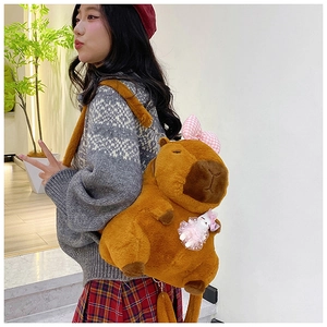 Brown plush Capybara backpack with pink checkered bow and hanging doll on a model