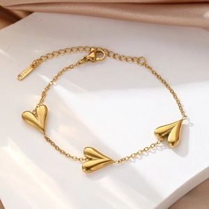 Detail view of the gold-plated stainless steel heart bracelet with S.STEEL engraving