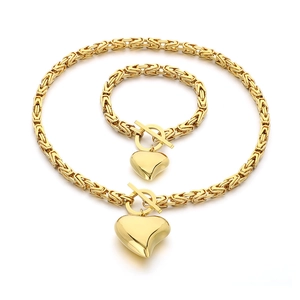 Golden Byzantine chain jewelry set featuring a heart pendant and toggle clasp