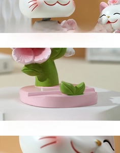 Detailed view of lucky cat phone holder with wide slot and hand-painted resin flowers