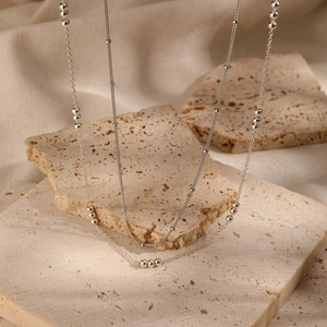 Double-layer silver S925 sterling silver necklace with beads on beige stone