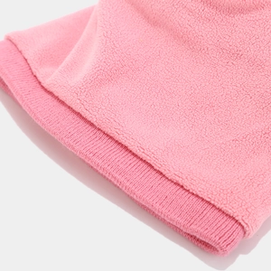 Detail of pink fleece fabric with fine stitching and soft ribbed cuffs on winter accessory