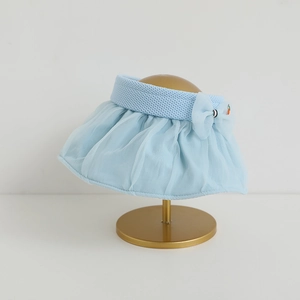 Detail of blue sun visor hat featuring a mesh brim and decorative bow with carrot accent