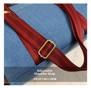 Detail of adjustable strap with gold buckle on blue denim tote bag for women