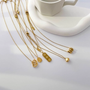 Elegant 18K gold plated necklaces featuring heart, floral and star pendants on white background