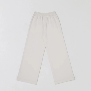 Detail view of cream white cotton wide-leg joggers with elastic waistband and drawstring