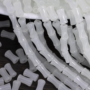Macro shot of white translucent bamboo-shaped glass beads for DIY jewelry making projects
