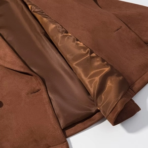 Detailed view of dark brown suede jacket featuring smooth satin lining and fine stitching