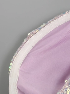 Macro detail of purple knit fabric with shimmering rainbow sequins and fine stitching